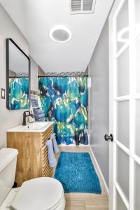 a bathroom with a toilet and a blue rug at Comfort Stay in Boston +50 photos