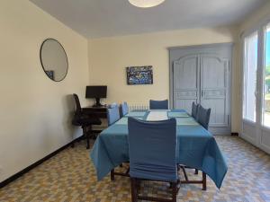 a room with a table and chairs and a mirror at Lake Villa Castéra-Verduzan in Castéra-Verduzan