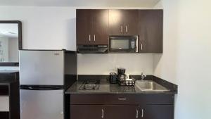 a small kitchen with a sink and a microwave at Studio 6 Greenville, SC in Greenville