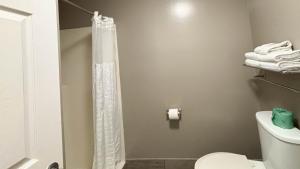 a bathroom with a shower curtain and a toilet at Studio 6 Greenville, SC in Greenville +33 photos