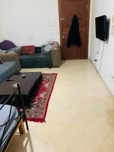 a living room with a couch and a table and a door at Omrane in Tunis