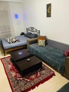 a living room with a bed and a coffee table at Omrane in Tunis
