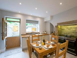 a kitchen with a wooden table with food on it at 2 Bed in Skipton oc-75646 in Grassington +10 photos