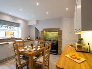 a kitchen with a wooden table and chairs in a kitchen at 2 Bed in Skipton oc-75646 in Grassington