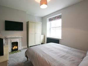 a bedroom with a bed and a fire place at 2 Bed in Skipton oc-75646 in Grassington