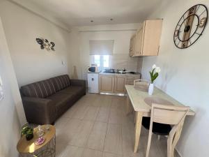 a kitchen and living room with a couch and a table at Sea View Apts & Suites by Pachiplex in Malia