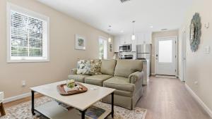 a living room with a couch and a table at Treehouse at BootLegger Cove in Bluffton