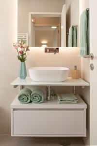 a bathroom with a white sink and a mirror at Allegro Patio House in Porto