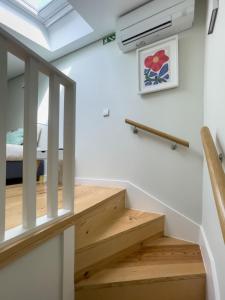 a staircase in a tiny house with a skylight at Allegro Patio House in Porto +15 photos