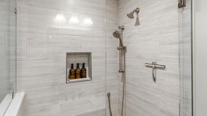 a bathroom with a shower with bottles of beer at Treehouse at BootLegger Cove in Bluffton +17 photos