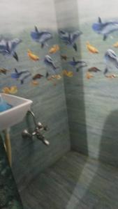 a flock of birds flying over a bathroom shower at OM Homestay in Dwarka