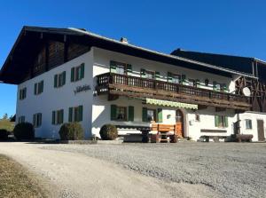a large white building with a balcony on it at Ferienwohnung Kollerlehen in Bischofswiesen