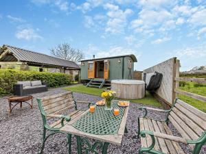 a backyard with a table and two chairs and a caravan at 1 Bed in Bala oc-85259 in Frongoch