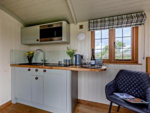 a kitchen with a counter and a sink and a chair at 1 Bed in Bala oc-85259 in Frongoch