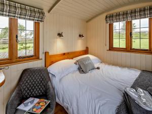a bedroom with a bed and a chair in it at 1 Bed in Bala oc-85259 in Frongoch