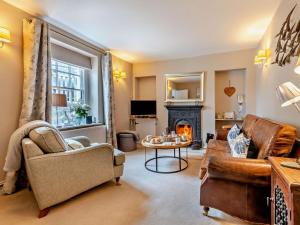 a living room with a couch and a fireplace at 3 Bed in Swanage oc-ic098 in Swanage