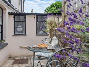 a table with a tea kettle and a plate of bread at 3 Bed in Swanage oc-ic098 in Swanage