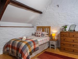 a bedroom with a bed and a brick wall at 1 Bed in Brecon oc-bn336 in Talgarth