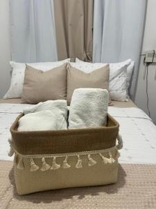 a bed with pillows on it with a box on it at Calm Stay Monte Plata in Monte Plata