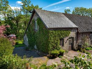 an old stone house covered in ivy at 1 Bed in Brecon oc-bn336 in Talgarth
