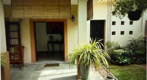 a front door of a house with a plant at Chevita Villa in Malabe