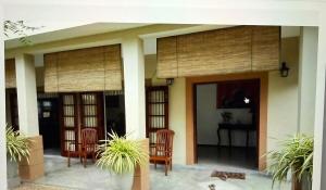 a house with two chairs and a table in it at Chevita Villa in Malabe