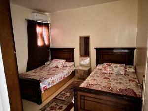 a bedroom with two beds and a window at Lasirena in Ain Sokhna