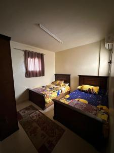 a bedroom with two beds and a window at Lasirena in Ain Sokhna