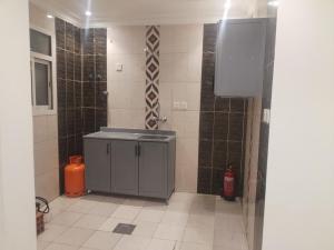 a bathroom with a shower and a sink in a room at غرف عزاب وشقق عوايل in Riyadh
