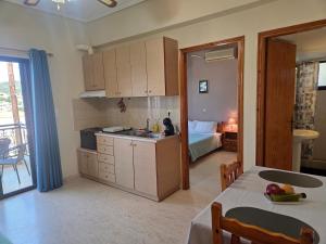 a kitchen and a bedroom with a bed and a table at Elea rooms 7 in Elia Laconias