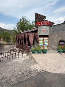 a restaurant with a sign on the side of a building at Guest House in Halidzor