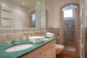 a bathroom with a sink and a toilet and a mirror at Port-Grimaud - La Maisonnette - sur plage et front de mer in Grimaud +18 photos