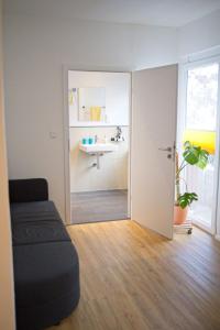 a bathroom with a sink and a couch in a room at Haus RAuszeit in Wildemann +34 photos