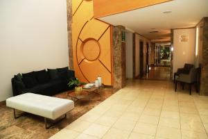 a living room with a couch and a table at Promenade Pancetti Belo Horizonte in Belo Horizonte