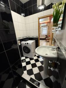 a bathroom with a sink and a washing machine at Casa Di Porto in Kotor