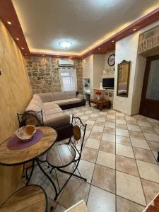 a living room with a couch and a table at Casa Di Porto in Kotor