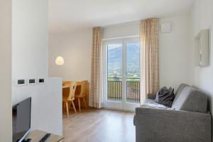 a living room with a couch and a table at Ferienappartement Freiblick in Marlengo