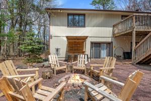 a group of chairs around a fire pit in front of a house at Good Lodge - Hot Tub Beach Access Pool Table in Lake Harmony