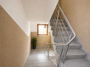 a staircase in a house with a metal railing at Pensjonat Semida in Władysławowo +43 photos