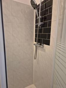 a shower with a shower head in a bathroom at The Old Victoria in Penrith +18 photos