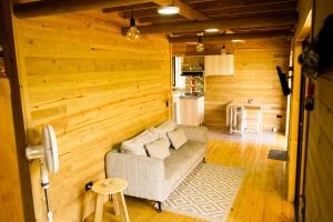 a living room with a couch and a kitchen at El Canto del Manglar in Nuquí