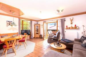 a living room with a couch and a table at Ferienwohnung Elisabeth in Reit im Winkl
