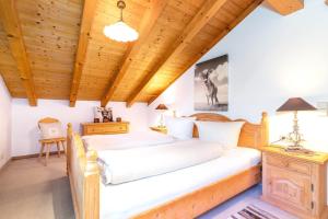 a bedroom with a bed and a wooden ceiling at Ferienwohnung Elisabeth in Reit im Winkl
