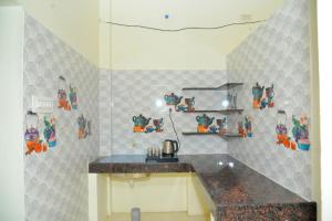 a kitchen with a counter and a counter top at Arun Lodge and Cottage Near Thiruchendur in Korkai