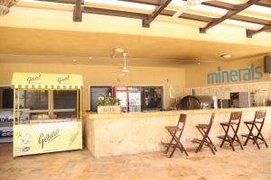 a restaurant with a counter with chairs around it at Apartment at Samarah Resort DeadSea C13-Families & couples only in Sowayma