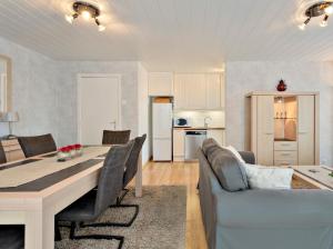 a kitchen and living room with a table and a couch at Ringlaan 70 2V0201 in Wenduine