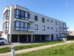a white building with a car parked in front of it at Ringlaan 70 2V0201 in Wenduine +11 photos