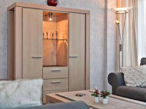a large wooden cabinet with a glass door in a living room at Ringlaan 70 2V0201 in Wenduine