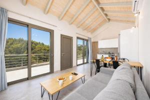 a living room with a couch and a table at Villa Angela in Trapezaki