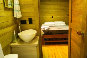 a small bathroom with a sink and a bed at El Canto del Manglar in Nuquí +14 photos
